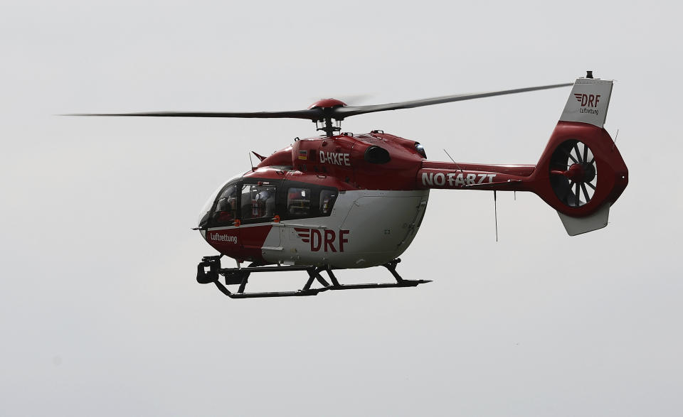 A rescue helicopter from the German Air Rescue Service (DRF) is in action over the scene of the accident on the A9, near Schkeuditz, Germany, Wednesday, March 27. 2024. (Jan Woitas/dpa via AP)