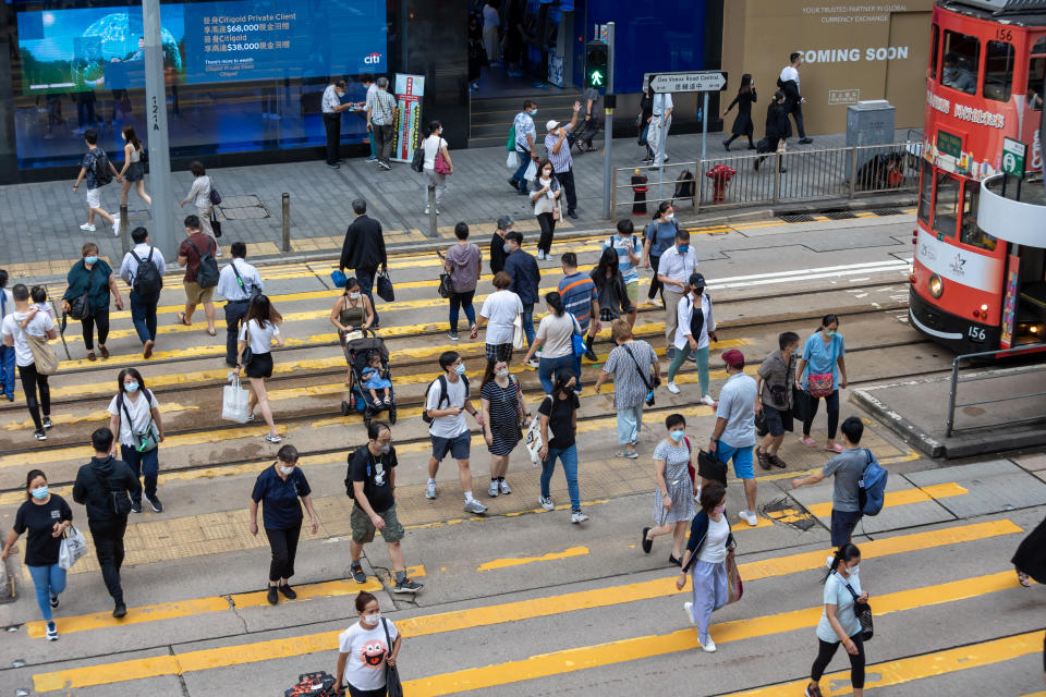 Hong Kong - July 7, 2022 : Pedestrians walk past the Des Voeux Road Central in Central, Hong Kong. Des Voeux Road Central was named after the 10th Governor of Hong Kong, Sir William Des Vœux.