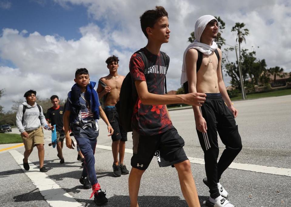 Students from West Boca high school students arrive at Marjory Stoneman Douglas after walking out in protest.