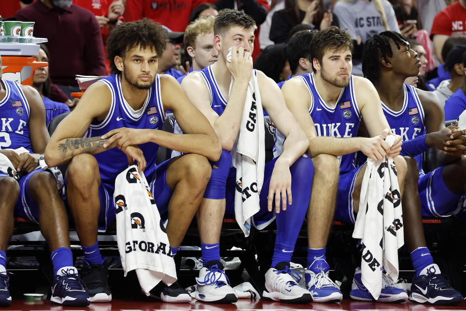 Duke's Dereck Lively II, Kyle Filipowski and Ryan Young, from left, sit on the bench during the closing minutes of the team's NCAA college basketball game against North Carolina State in Raleigh, N.C., Wednesday, Jan. 4, 2023. (AP Photo/Karl B DeBlaker)