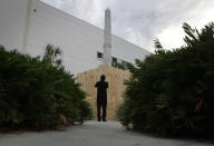 <p>TA vistor takes pictures of a statue that has plywood boards covering part of the statue that shows two figures of Confederate soldiers in front of the Hillsborough Country Courthouse as the city plans to move the statue in the midst of a national controversy over whether Confederate symbols should be removed from public display on August 18, 2017 in Tampa, Fla. (Photo: Joe Raedle/Getty Images) </p>