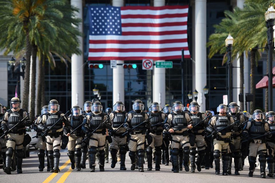 Florida State Troopers move down North Clay Street as they disperse protesters from in front of the Duval County Courthouse  in Jacksonville, Florida on May 31, 2020.