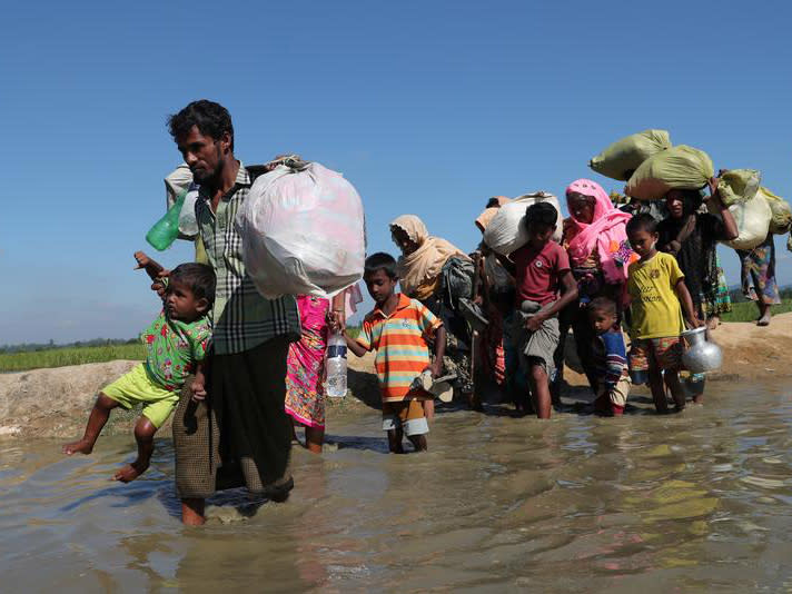 Rohingya refugees walk towards a refugee camp after crossing the border in Anjuman Para near Cox's Bazar, Bangladesh: Reuters