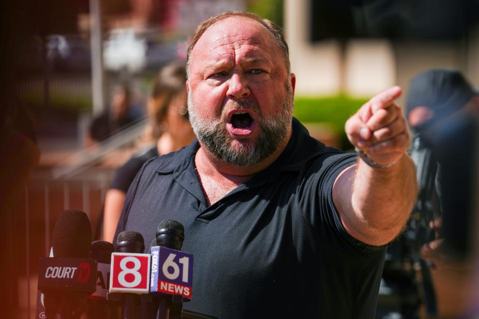InfoWars founder Alex Jones speaks to the media outside Waterbury Superior Court during his trial on September 21, 2022 in Waterbury, Connecticut. Jones is being sued by several victims' families for causing emotional and psychological harm after they lost their children in the Sandy Hook massacre. A Texas jury last month ordered Jones to pay $49.3 million to the parents of 6-year-old Jesse Lewis, one of 26 students and teachers killed in the shooting in Newtown, Connecticut.