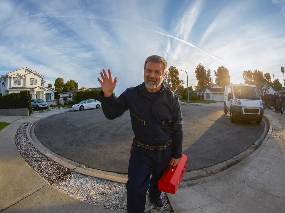 A worker approaches an Amazon Ring security camera.