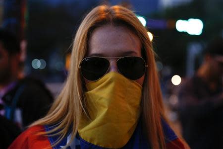 A Venezuelan protester poses for a portrait at Altamira square in Caracas March 14, 2014. REUTERS/Jorge Silva