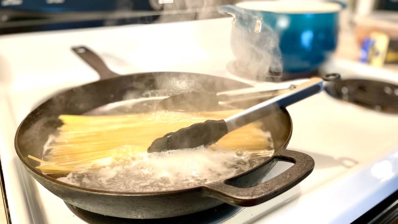 pasta cooking in skillet
