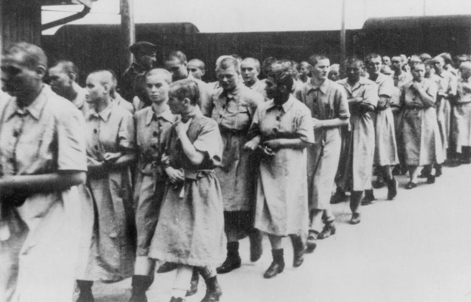 <span class="caption">Women prisoners at the Auschwitz train station around 1944. </span> <span class="attribution"><a class="link " href="https://www.gettyimages.com/detail/news-photo/germany-third-reich-concentration-camps-1939-45-women-at-news-photo/545959785?adppopup=true" rel="nofollow noopener" target="_blank" data-ylk="slk:ullstein bild via Getty Images;elm:context_link;itc:0;sec:content-canvas">ullstein bild via Getty Images</a></span>