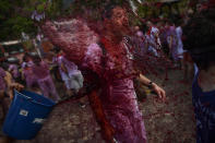 <p>A man has wine thrown on his as he takes part in a wine battle, in the small village of Haro, northern Spain, Friday, June 29, 2018. (Photo: Alvaro Barrientos/AP) </p>