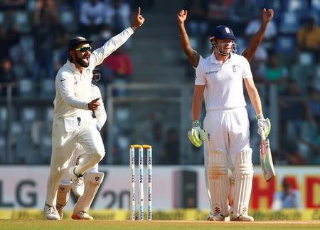 Cricket - India v England - Fourth Test cricket match - Wankhede Stadium, Mumbai - 12/12/16. India's Virat Kohli (L) celebrates the wicket of England's Jonny Bairstow. REUTERS/Danish Siddiqui