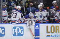 Edmonton Oilers' Stuart Skinner, Vincent Desharnais, Calvin Pickard, Cody Ceci, Darnell Nurse and Corey Perry, from left, stand on the bench during the final seconds of Game 5 of the team's NHL hockey Stanley Cup second-round playoff series against the Vancouver Canucks, Thursday, May 16, 2024, in Vancouver, British Columbia. (Darryl Dyck/The Canadian Press via AP)