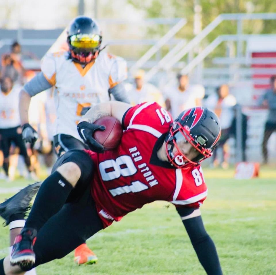 Southeast Michigan Red Storm tight end Tyler Hammack goes to the ground after making a catch in the season opener against the Glass City Tigers on Saturday, May 7, 2022.