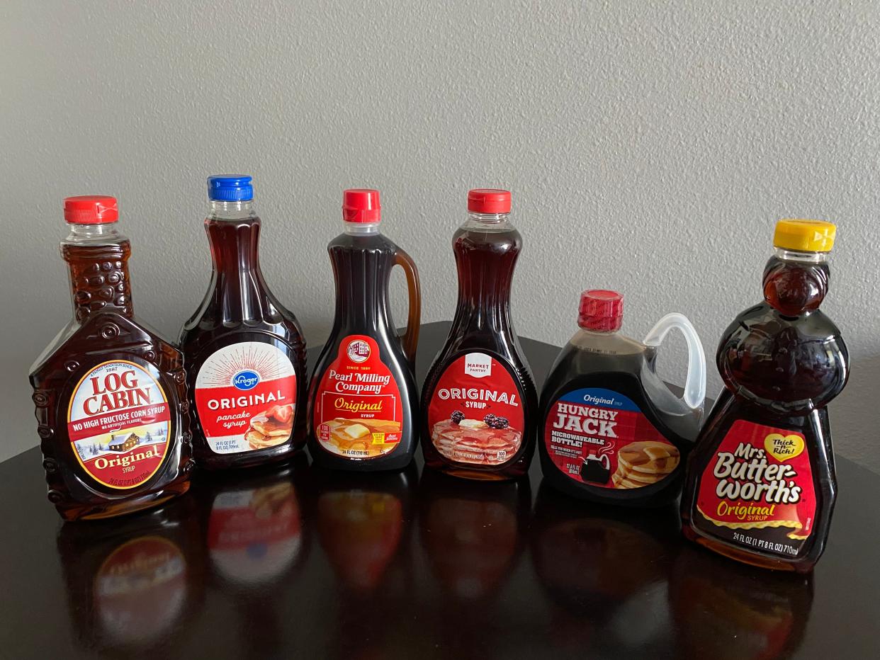 six pancake syrups from the grocery store lined up in a row