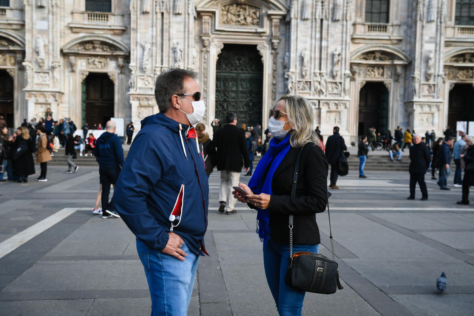 Man and woman stroll through the city with protective masks and sanitizing gels to counteract the possible infection of the ''CoronaVirus'',Milan,Italy, February 23,2020 (Photo by Andrea Diodato/NurPhoto via Getty Images)