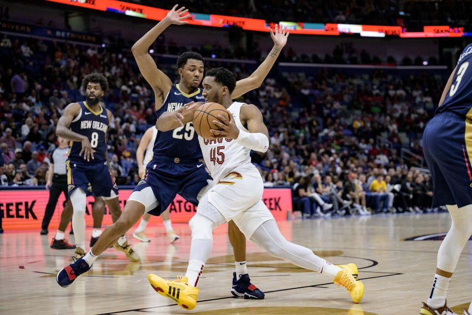 Cleveland Cavaliers guard Donovan Mitchell (45) drives around New Orleans Pelicans guard Trey Murphy III (25) during the second half of an NBA basketball game in New Orleans, Wednesday, March 13, 2024. (AP Photo/Matthew Hinton)