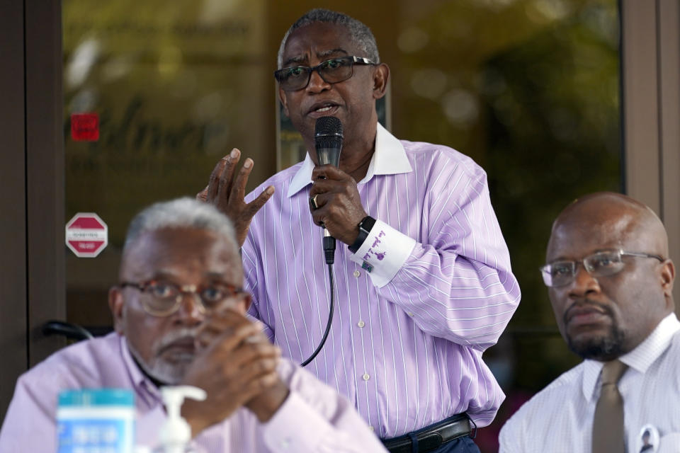 South Carolina State Sen. John Scott, center, with Rep. Leon Howard, left, and Minister Kelvin Briggs, speaks during a prayer vigil in remembrance of Cyrus Carmack-Belton, Friday, June 2, 2023, in Columbia, S.C. Cyrus Carmack-Belton, a 14-year-old boy will be laid to rest less than one week after officials say a South Carolina gas station owner gunned him down in a killing that has prompted cries of racial profiling.(AP Photo/Erik Verduzco)