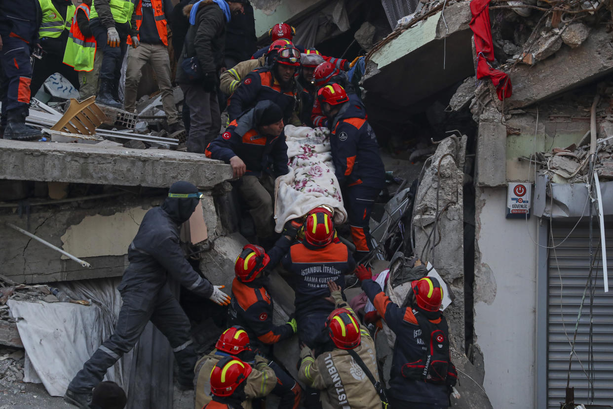 Turkish rescue workers carry Ergin Guzeloglan, 36, to an ambulance after pulled him out from a collapsed building five days after the earthquake, in Hatay, southern Turkey, early Saturday, Feb. 11, 2023. Emergency crews made a series of dramatic rescues in Turkey on Friday, pulling several people, some almost unscathed, from the rubble, four days following a catastrophic earthquake.(AP Photo/Can Ozer)