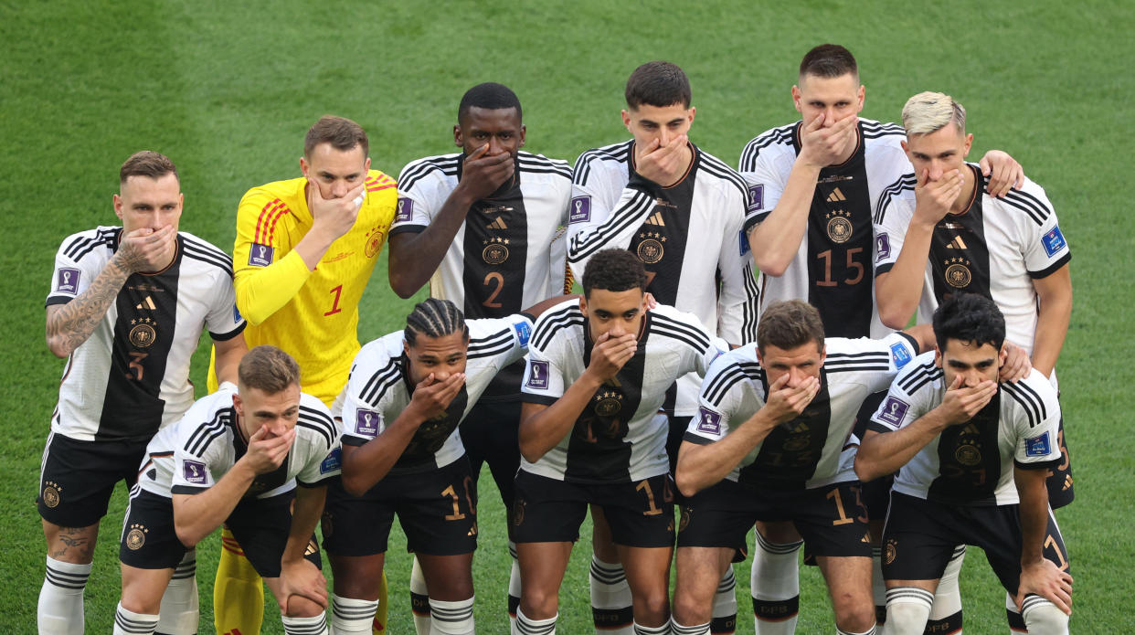 Germany players pose for a team group photo covering their mouths before their World Cup match against Japan. 