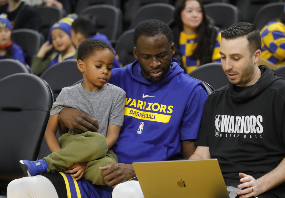 SAN FRANCISCO, CALIFORNIA - FEBRUARY 06: Golden State Warriors Draymond Green #23 and his son Jamal D.J. Green, look over notes during warmups before their NBA game against the Oklahoma City Thunder at the Chase Center in San Francisco, Calif., on Monday, Feb.6, 2023. (Jane Tyska/Digital First Media/East Bay Times via Getty Images)