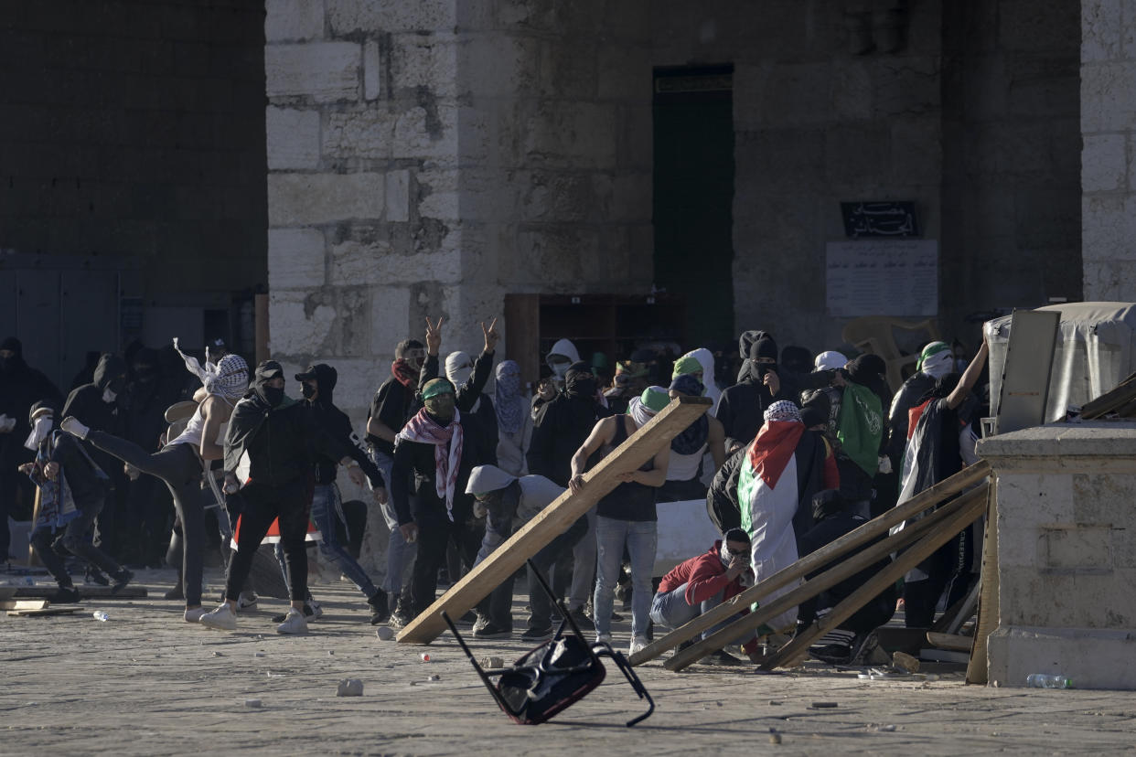 Palestinians clash with Israeli security forces at the Al Aqsa Mosque compound in Jerusalem's Old City Friday, April 15, 2022. (AP Photo/Mahmoud Illean)