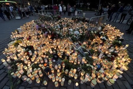 Memorial cards, candles and flowers for the victims of Friday's stabbings are placed on the Market Square in Turku, Finland August 19, 2017. Lehtikuva/Vesa Moilanen/via REUTERS