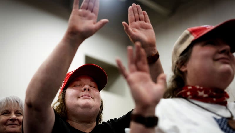 Misty Grace of Green Bay, Wis., center, who describes herself as a follower of Jesus Christ, prays during a rally for former President Donald Trump at the KI Convention Center in Green Bay, Wis., on Tuesday, April 2, 2024.