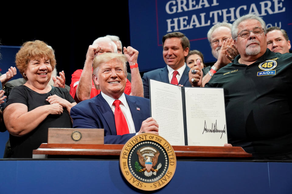 U.S. President Donald Trump holds up an executive order on Medicare he signed during an event at The Villages retirement community in The Villages, Florida, U.S., October 3, 2019. REUTERS/Kevin Lamarque