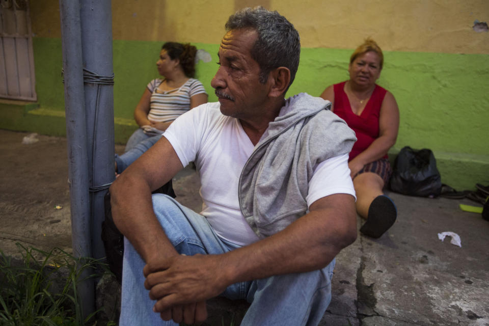 Santos Quiroz, a migrant from Honduras, waits in the street early in the morning next to the Mexican Commission for Migrant Assistance office, for his turn to get the documents needed that allows him to stay in Mexico, in Tapachula, Thursday, June 20, 2019. The flow of migrants into southern Mexico has seemed to slow in recent days as more soldiers, marines, federal police, many as part of Mexico's newly formed National Guard, deploy to the border under a tougher new policy adopted at a time of increased pressure from the Trump administration. (AP Photo/Oliver de Ros)