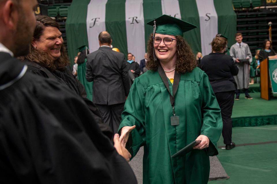 Fossil Ridge High School graduate Rielle Artis shakes hands with school administrators after receiving her high school diploma during the Fossil Ridge High School commencement ceremony at Moby Arena in Fort Collins on May 21.