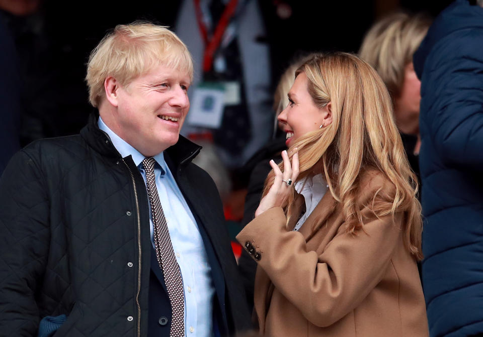 Prime Minister Boris Johnson and partner Carrie Symonds in the stands during the Guinness Six Nations match at Twickenham Stadium, London.