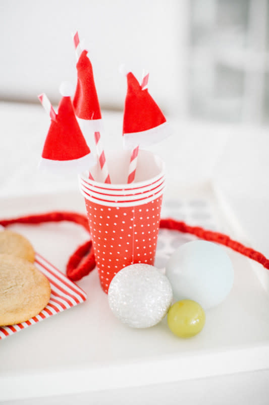 <p>Sugar & Cloth</p><p>While you’re cooking your Christmas dinner, have your kids whip up some festive Santa hats that they can attach to all the straws that will go in the drinks at your table. See how to do it at <em><a href="https://sugarandcloth.com/diy-one-minute-santa-hat-drink-stirrers/" rel="nofollow noopener" target="_blank" data-ylk="slk:Sugar & Cloth;elm:context_link;itc:0;sec:content-canvas" class="link ">Sugar & Cloth</a></em>.</p>