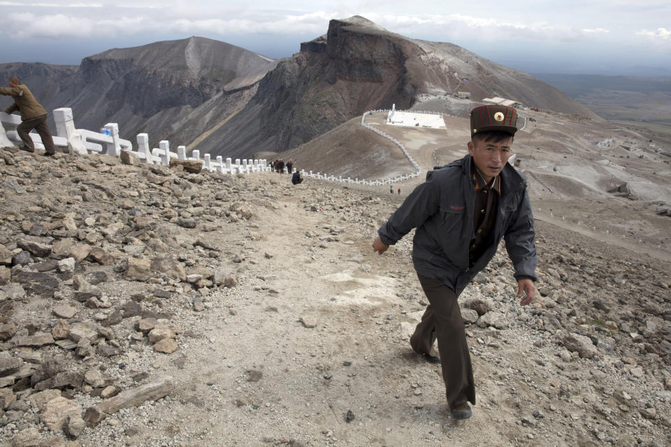 FILE - In this Aug. 18, 2018, file photo, a North Korean soldier walks up the slopes on Mount Paektu in North Korea. There is no more sacred a place in North Korea than Mount Paektu. The still active volcano, site of one the most violent eruptions in history, is considered to be the spiritual epicenter of the North Korean revolution. (AP Photo/Ng Han Guan, File)