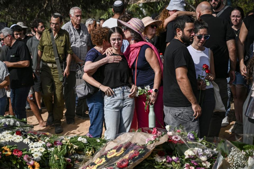 Relatives and friends mourn during the funeral of David Carroll who was killed by Palestinian Hamas militants on October 7, in Kibbutz Beeri, during his funeral in Revivim in southern Israel on October 22, 2023, amid the ongoing battles between Israel and the Palestinian group Hamas. Thousands of people, both Israeli and Palestinians have died since October 7, 2023, after Palestinian Hamas militants entered Israel in a surprise attack leading Israel to declare war on Hamas in the Gaza Strip enclave on October 8.