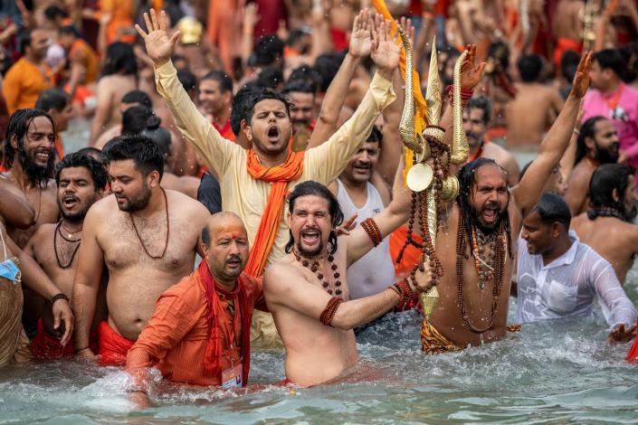 Sadhus, or Hindu holy men take a dip in the Ganges river during Shahi Snan at 