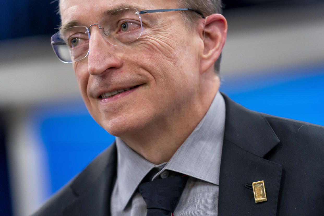Intel CEO Patrick Gelsinger wears a lapel pin made out of a computer chip that he designed, following Intel's announcement to invest in an Ohio chip making facility, at the South Court Auditorium in the Eisenhower Executive Office Building on the White House Campus in Washington, Friday, Jan. 21, 2022. (AP Photo/Andrew Harnik)