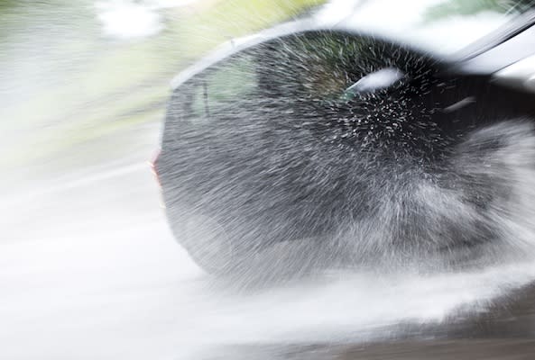 A car drives through a large paddle during heavy rainfalls in Berlin, Germany, Saturday, July 14, 2012. A weekend with rain and thunderstorms is forecasted for large parts of Germany. (AP Photo/Gero Breloer)