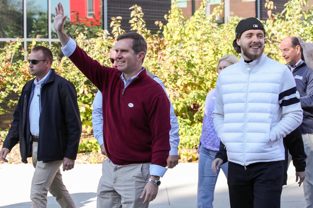 Gov. Andy Beshear (left) campaigned with rapper Jack Harlow on Thursday at the University of Louisville. Beshear and challenger Daniel Cameron were tied in a poll released Friday.