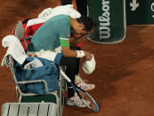 Japan's Kei Nishikori sits in his chair and looks down during a change of ends as he plays against Germany's Alexander Zverev during their fourth round match on day 8, of the French Open tennis tournament at Roland Garros in Paris, France, Sunday, June 6, 2021. (AP Photo/Michel Euler)