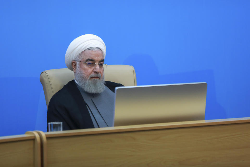 In this photo released by the official website of the office of the Iranian Presidency, President Hassan Rouhani attends a meeting with the Health Ministry officials in Tehran, Iran, Tuesday, June 25, 2019. Rouhani said the new U.S. sanctions targeting the Islamic Republic's supreme leader and others are "outrageous and idiotic." The comments by Hassan Rouhani come a day after the Trump administration sanctioned Supreme Leader Ayatollah Ali Khamenei and his associates. (Iranian Presidency Office via AP)