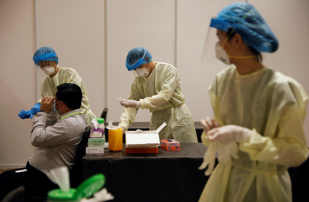 An attendee receives a nose swab as part of a coronavirus disease (COVID-19) antigen rapid test before a conference held by the Institute of Policy Studies at Marina Bay Sands Convention Centre in Singapore January 25, 2021. Picture taken January 25, 2021. REUTERS/Edgar Su