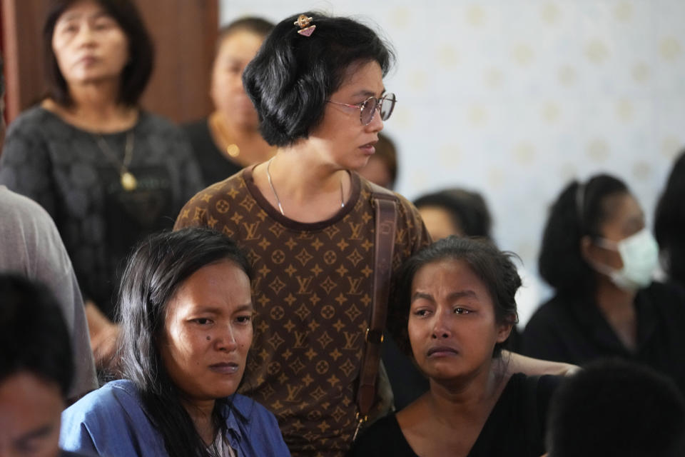 Relatives of a victim in an explosion at a fireworks factory cry at Rong Chang temple in Suphan Buri province, Thailand, Thursday, Jan. 18, 2024. The blast in central Thailand killed multiple people on Wednesday, according to provincial officials, though the devastation at the scene has made the death toll uncertain. (AP Photo/Sakchai Lalit)