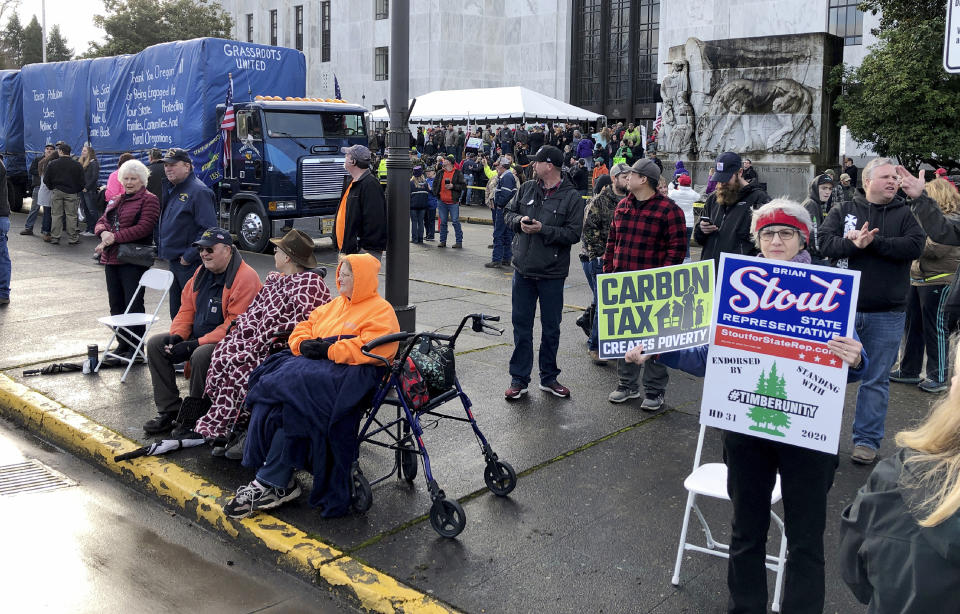 FILE - In this Feb. 6, 2020 file photo, demonstrators protest against a cap-and-trade bill aimed at stemming global warming protest at the Oregon State Capitol in Salem. Republican lawmakers on Monday, Feb. 24, 2020 boycotted the Oregon Senate in an effort to deny Democrats a quorum and doom a contentious climate change bill. (AP Photo/Andrew Selsky)