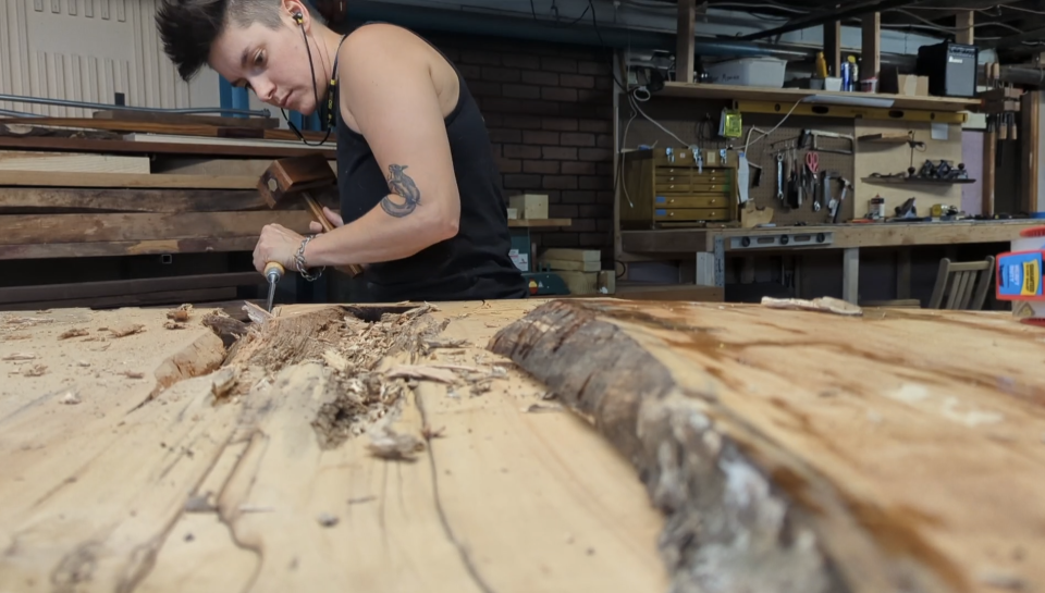 EJ Duff-Berger carves into a piece at a workshop.