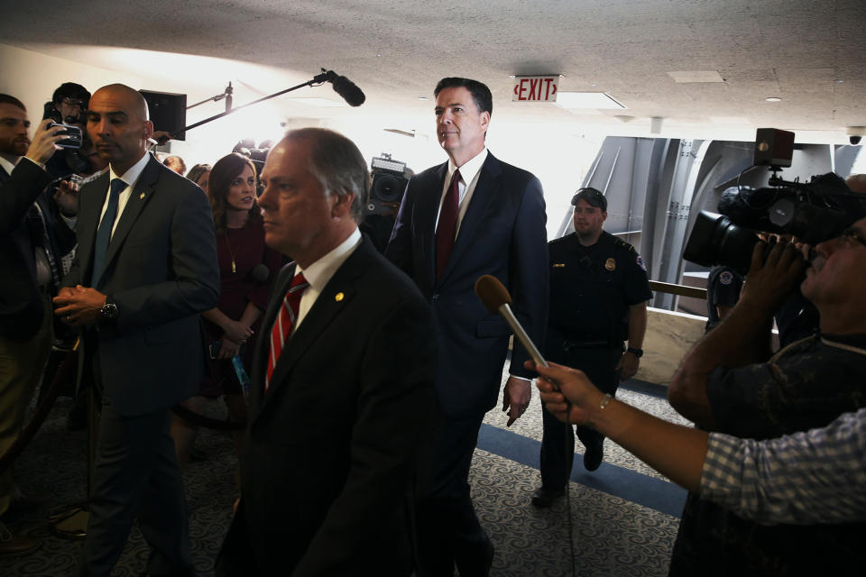 <p>Former FBI Director James Comey (wearing solid red tie) is escorted as he departs after testifying before a Senate Intelligence Committee hearing on Russia’s alleged interference in the 2016 U.S. presidential election on Capitol Hill in Washington, June 8, 2017. (Photo: Jonathan Ernst/Reuters) </p>