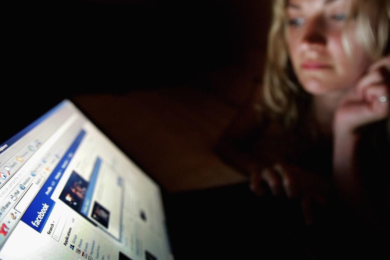 In this photo illustration a girl browses the social networking site Facebook on July 10, 2007 in London, England.