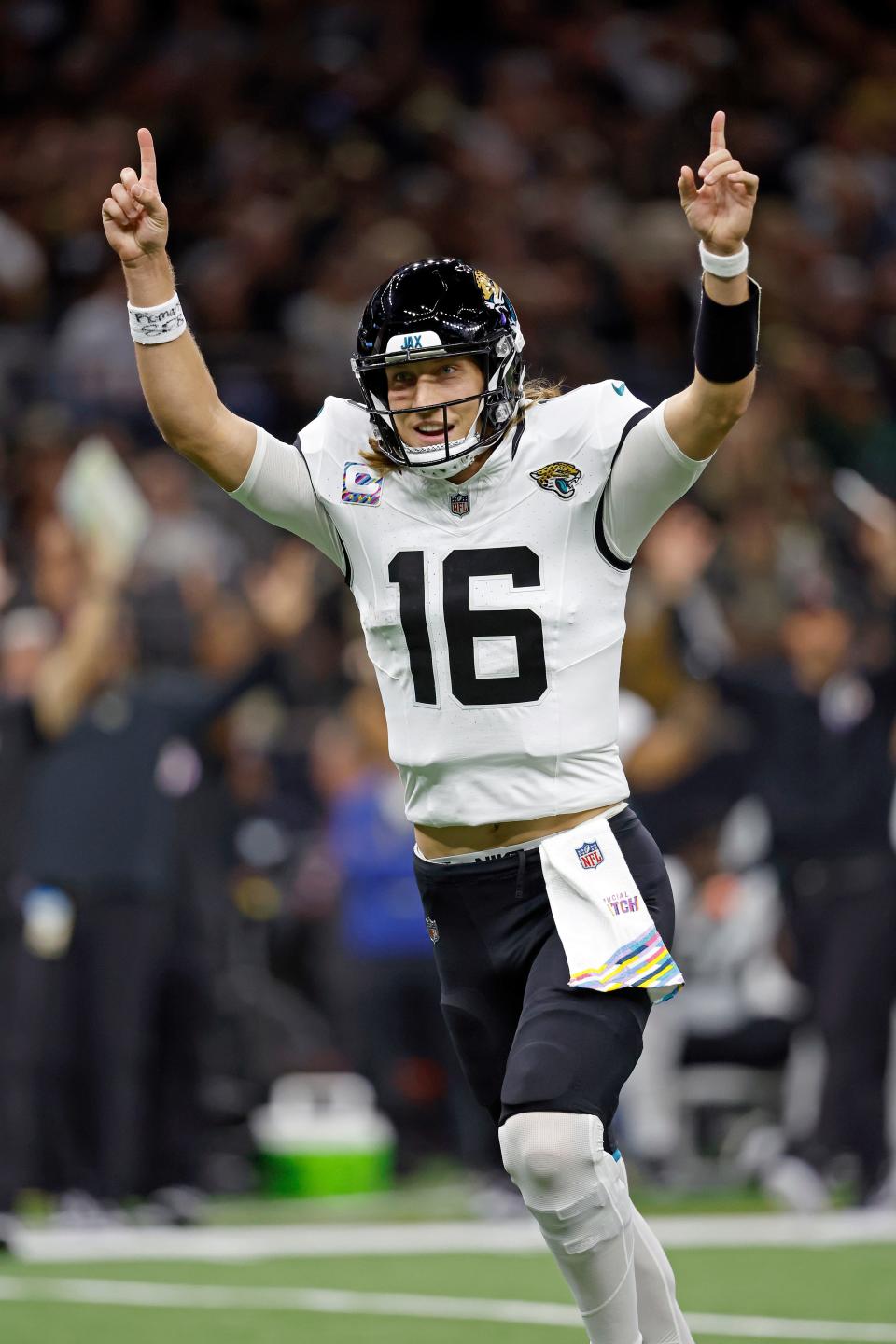 Jacksonville Jaguars quarterback Trevor Lawrence (16), seen here celebrating his team's touchdown in Thursday's 31-24 victory over the New Orleans Saints, validated his toughness by playing on a gimpy left knee and throwing the game-winning TD pass to Christian Kirk in the late stages of the fourth quarter.