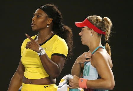 Serena Williams of the U.S. (L) talks to the umpire as Germany's Angelique Kerber walks past during their final match at the Australian Open tennis tournament at Melbourne Park, Australia, January 30, 2016. REUTERS/Issei Kato