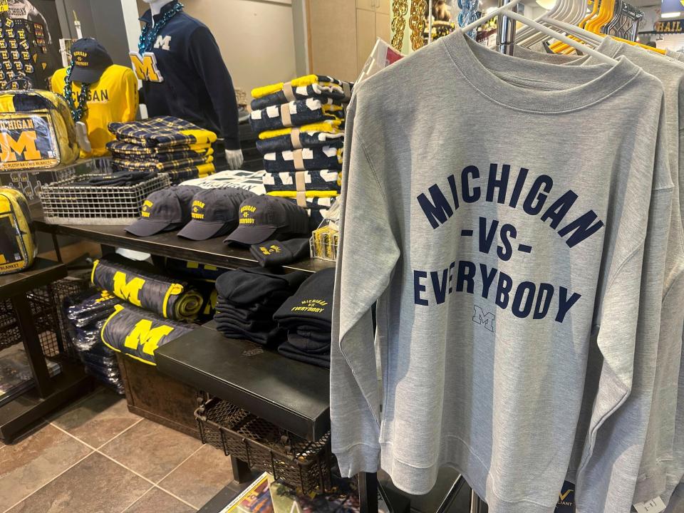 Michigan Vs. Everybody knit hats, ball caps, sweatshirts and T-shirts were flying off the racks and plucked off a table at The M Den, a retail store near the University of Michigan campus in Ann Arbor, Mich. Sunday, Nov. 12, 2023. The second-ranked Wolverines headed into a fateful week with a court hearing, a road trip to Maryland and a swagger built on their growing belief that it’s them against the world. The school is preparing for its legal battle fight to free Jim Harbaugh from a Big Ten suspension.