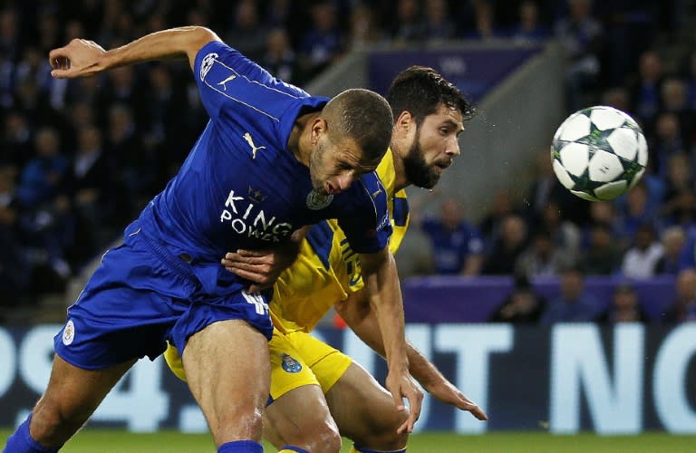 Leicester City's Algerian striker Islam Slimani (L) scores his team's first goal against Porto at the King Power Stadium in Leicester, central England on Septmeber 27, 2016