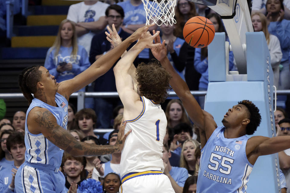 North Carolina forwards Armando Bacot, left, and Harrison Ingram (55) battle UC Riverside center Benjamin Griscti (1) for a rebound during the first half of an NCAA college basketball game Friday, Nov. 17, 2023, in Chapel Hill, N.C. (AP Photo/Chris Seward)